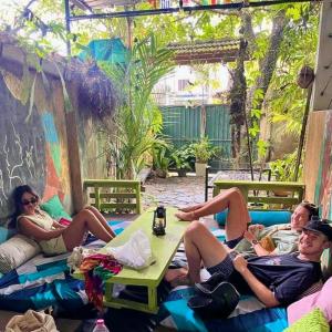 a group of people sitting on a couch at Cycling Backpacker Hostel in Unawatuna