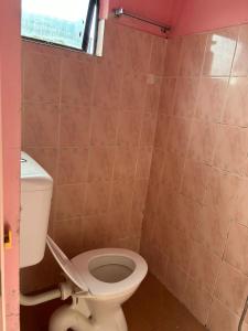 a bathroom with a toilet and a window at Hotel Cahaya in Tanjung Malim