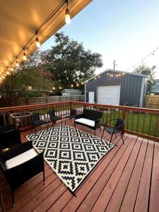 a patio with chairs and a rug on a deck at Veteran Owned Retreat with Games in Baton Rouge