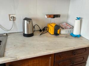 a kitchen counter with a coffee maker on a counter top at Casa de Amor in Luanda