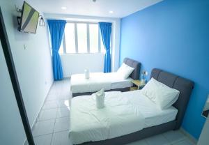 Postel nebo postele na pokoji v ubytování Gemilang Hotel Klang