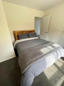 a bedroom with a large bed in a room at Sherwood Ranch Cottages - 405 Woodbank Road in Hanmer Springs