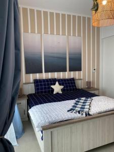 a bedroom with a bed with a star on it at Indigo beach residence 110 in Sharjah