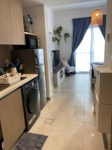 a kitchen with a washer and dryer in a room at Indigo beach residence 110 in Sharjah