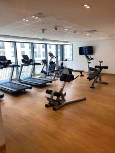 a gym with several treadmills and exercise bikes at Indigo beach residence 110 in Sharjah