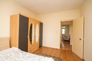 a bedroom with a bed and a wooden cabinet at south of Bayangol Hotel, 1 bedroom apartment 25-58 in Ulaanbaatar