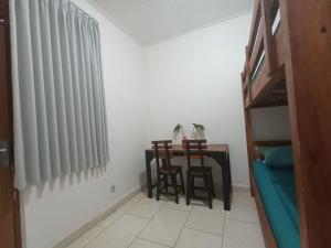 a room with a table and chairs and a window at Wijaya Hostel in Denpasar