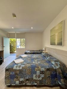 a bedroom with a large bed in a room at Time and Tide Hotel Motel in Collaroy