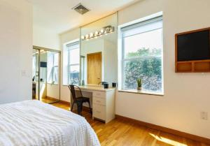 a bedroom with a bed and a desk and a tv at *RARE* Heated Pool *FREE* Parking w/ City Views in Philadelphia