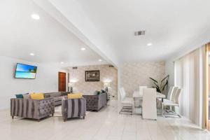 a living room with couches and a dining room at Welcome To Palm Springs Heatable Pool Spa FirePit Unique in Palm Springs