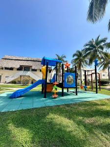 a playground with a slide in a park at Departamento Acapulco frente a la playa in Acapulco