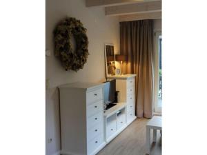 a living room with a white dresser and a television at Jäschner Villa Luftig in Remptendorf