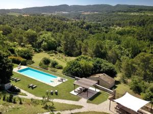 an aerial view of a villa with a swimming pool at Flat Riu d'Agost with garden terrace in La Torre de Claramunt