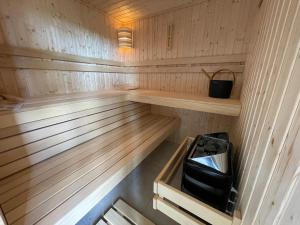a wooden sauna with a stove in it at Flat Riu d'Agost with garden terrace in La Torre de Claramunt