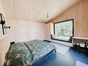 a bedroom with a bed and a window in a room at Super nice holiday home by the lake in Templin