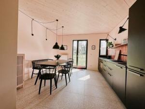 a kitchen and dining room with a table and chairs at Super nice holiday home by the lake in Templin