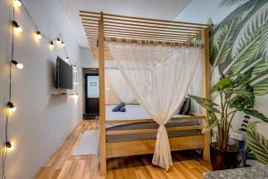 a bedroom with a bed with a mosquito net at Trinh's House - Hang Vai in Hanoi