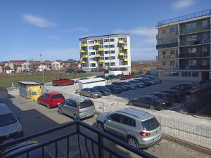 a parking lot with cars parked in front of a building at SuiteMateo in Cluj-Napoca