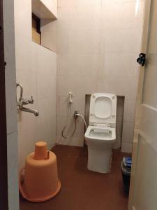 a bathroom with a toilet and a shower at Coorg HillTown Hotel - Madikeri in Madikeri