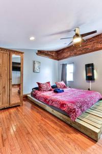 a bedroom with a bed with a pink comforter at *Rare* Entire Queen Village House w/ Pool Table in Philadelphia