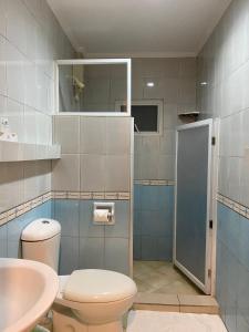 a bathroom with a toilet and a sink at Panglao Regents Park Resort in Panglao