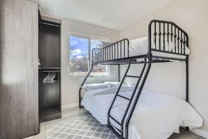 a bedroom with two bunk beds and a window at 411 S Owens St - Lakewood in Lakewood