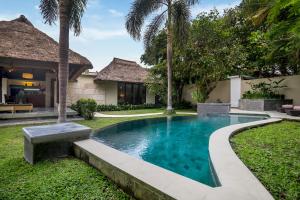 a swimming pool in the yard of a villa at Sayang Garden & Pool Vllla Ubud in Ubud