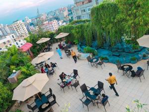 an overhead view of a patio with people sitting around a fountain at Hotel Elite Palace in Comilla