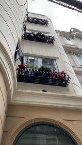 a building with two balconies with potted plants on it at Home in Ho Chi Minh City, D1 in Ho Chi Minh City
