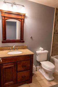 a bathroom with a toilet and a sink and a mirror at *RARE* Entire Society Hill House in Philadelphia