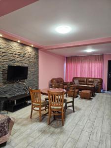 a living room with a couch and a table at Апартамент България със свободна зона за паркиране in Veliko Tŭrnovo