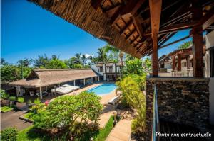 an exterior view of a resort with a swimming pool at Toparadis Guest House in Pereybere