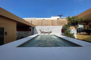 a swimming pool on the roof of a house at Blu Cabin Ari Stylish Gay Poshtel in Bangkok