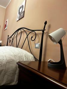 a bedroom with a bed and a desk with a lamp at Little's Venaria in Venaria Reale