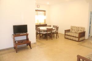 a living room with a dining room table and a chair at Mountain View Holidays in Colombo