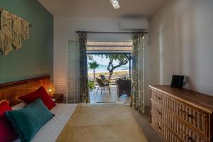 a bedroom with a bed and a view of the ocean at Quaint 3 BDR Beach Bungalow in a fishing village in Grande Gaube