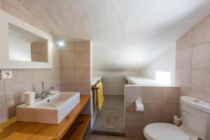a bathroom with a sink and a toilet at Quaint 3 BDR Beach Bungalow in a fishing village in Grande Gaube