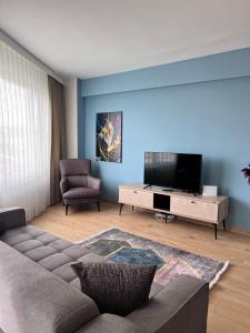 a living room with a couch and a flat screen tv at Allegro Apartments Kadıköy in Istanbul