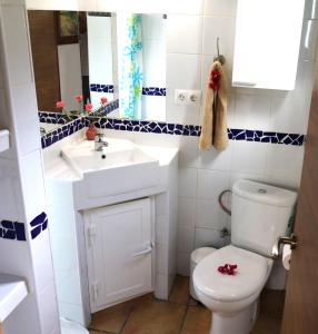 y baño con aseo blanco y lavamanos. en Chalet with private jacuzzi -Mi Dushi, en Tolox