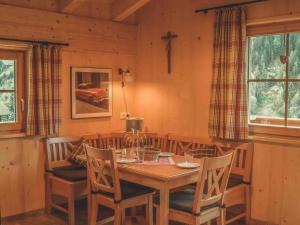 a dining room with a wooden table and chairs at Saerbeck mountain hut in Heiligenblut