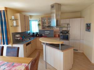 a kitchen with a table and a counter top at Michl"s Villa Modern retreat in Tarrenz