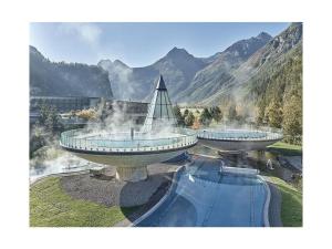 two observation towers with a fountain in the mountains at Michl"s Villa Modern retreat in Tarrenz