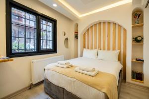 a bedroom with a bed with two towels on it at Emir Hotel in Istanbul