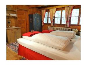 two large beds in a room with a kitchen at Mountain hut Hochpillberg Tyrol in Pill