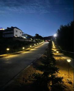 a street with lights on the side of the road at Eagle House in Bosteri