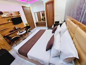 a bedroom with a large bed and a desk at Hotel TU Casa (Stay near International Airport) in New Delhi