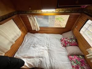 a bed in a room with a window and a couch at Caravan camp in Erdemli