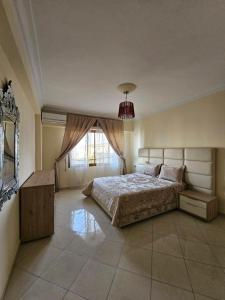 ein Schlafzimmer mit einem großen Bett und einem Fenster in der Unterkunft la perle du tanger R in Tangier