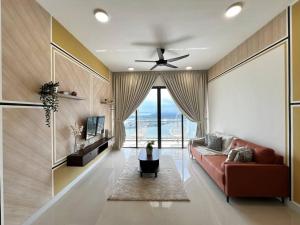 a living room with a couch and a ceiling fan at Bora Residences by Antlerzone in Johor Bahru