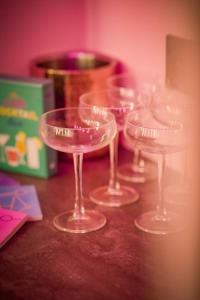 a group of wine glasses sitting on a table at The Ultimate Hen Suite with Bar & Makeup Room in Manchester